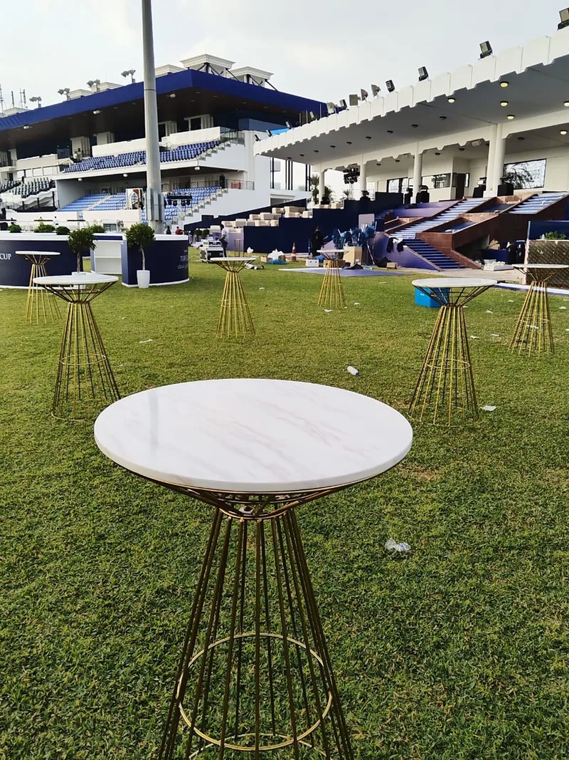 High cocktail tables and bar seating creating an outdoor networking environment at Abu Dhabi Turf Club.
