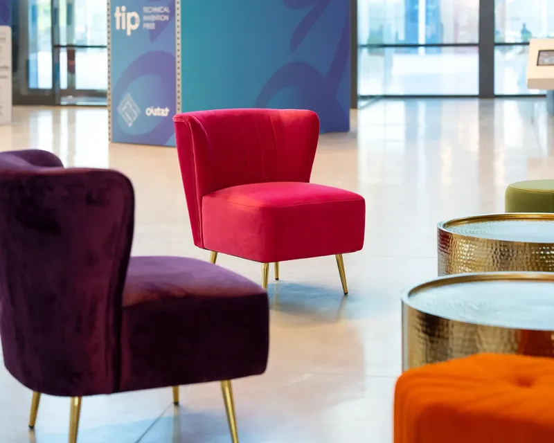 Vibrant hospitality lounge with contemporary armchairs and coffee tables at Sharjah Performing Arts Academy.
