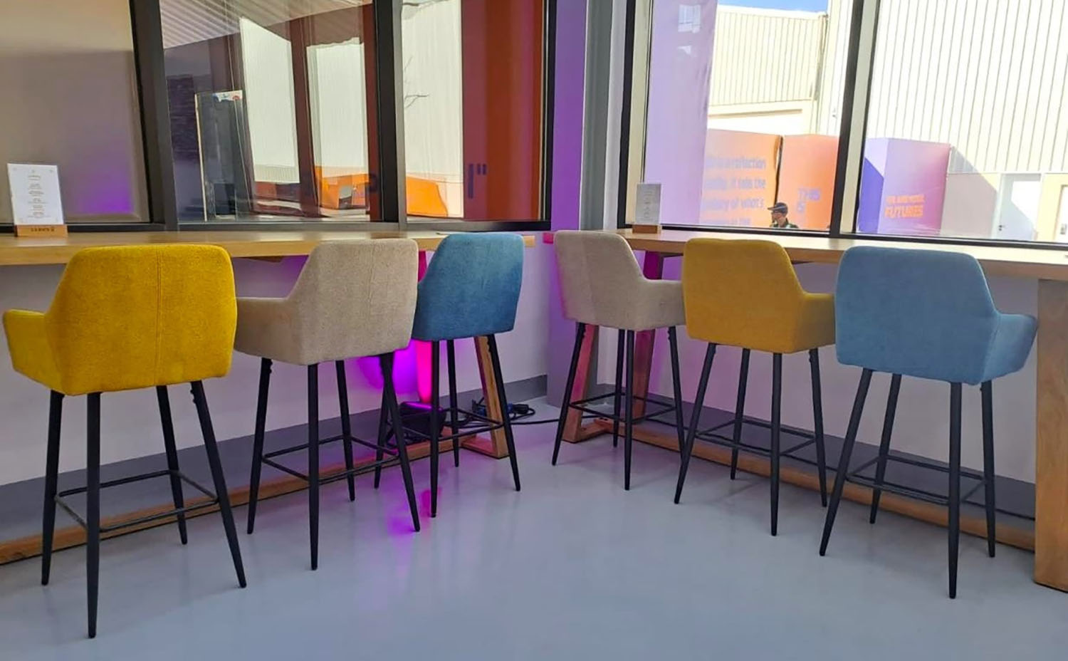 Mustard, beige and blue barstools creating a colourful counter seating arrangement