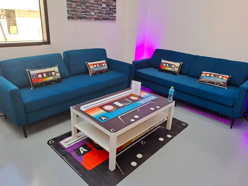 Evolution Furniture teal sofas and themed accessories completing a compact branded lounge setting