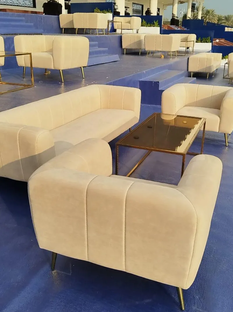 Luxury event lounge layout with coordinated cream seating and champagne gold furniture finishes.