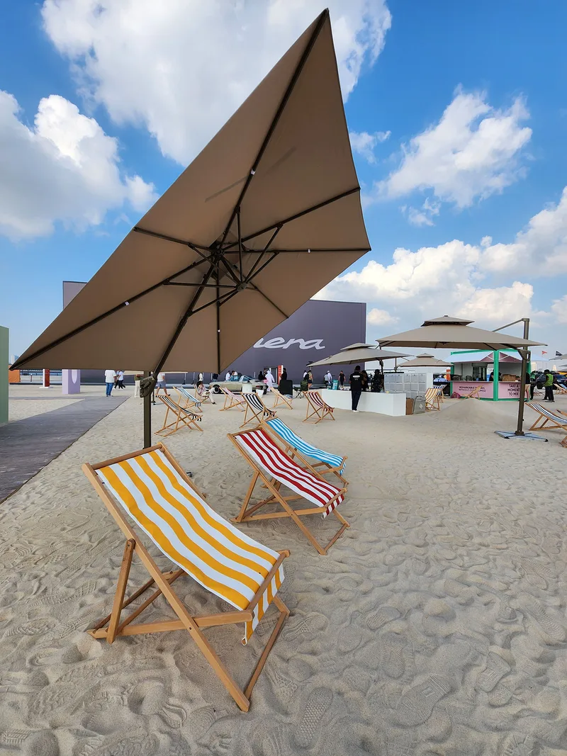 Premium outdoor hospitality furniture with umbrellas creating comfortable visitor seating at Dubai Design District.