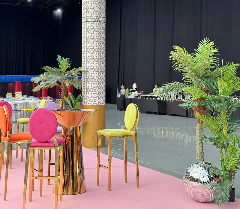 Dior bar stools and high tables creating vibrant social gathering spaces.