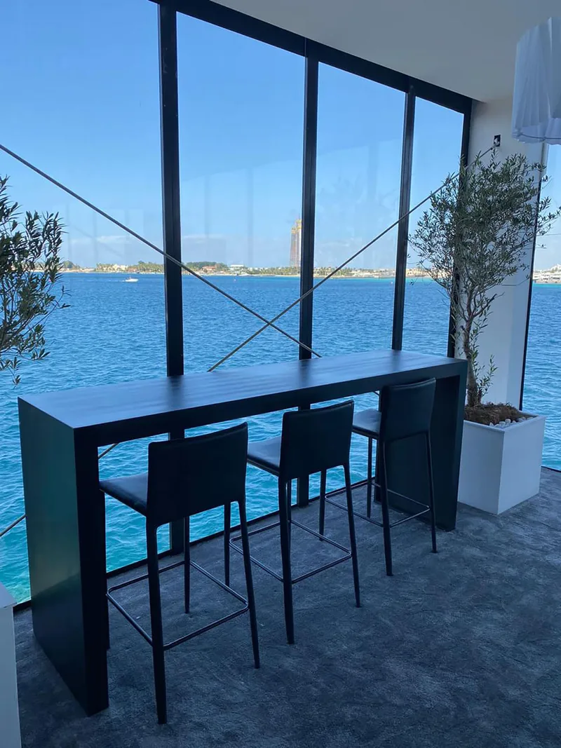 Modern event furniture arranged within an elegant VVIP hospitality environment overlooking Jeddah Corniche.
