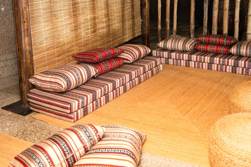 Stylish majlis seating with decorative cushions and modern coffee tables.