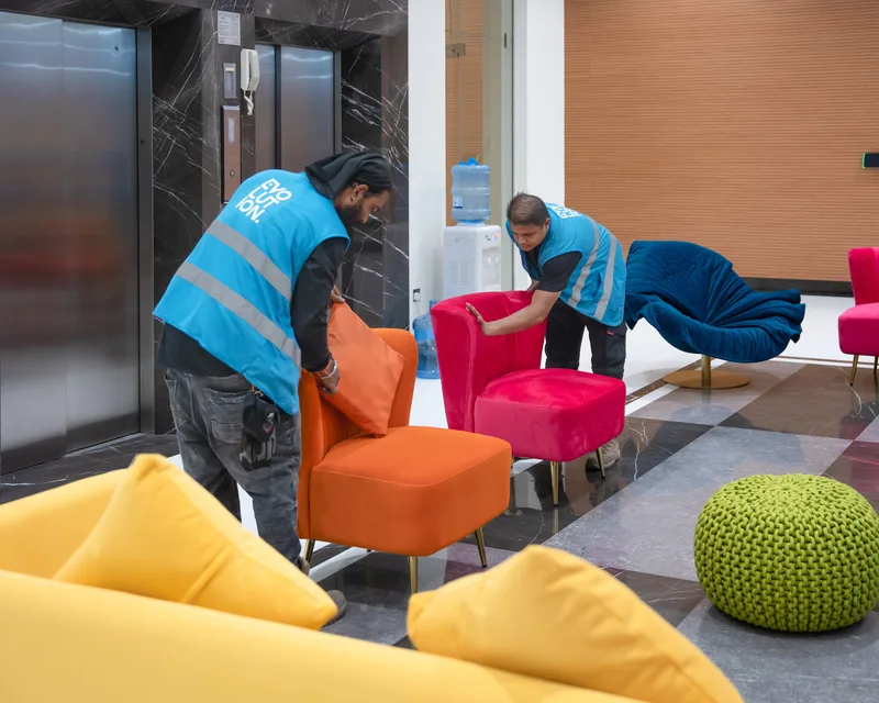 Evolution Furniture installation team positioning premium lounge seating before event opening.