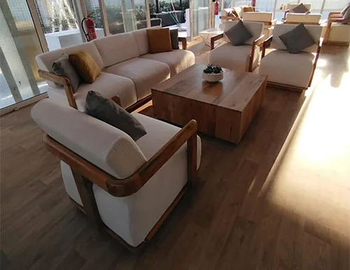 Majlis seating layout with natural timber furniture creating welcoming hospitality spaces.