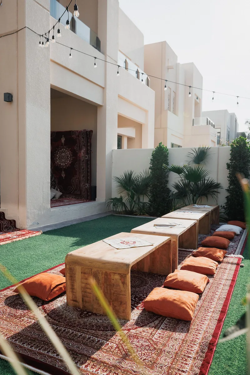 Low lounge seating arranged around handcrafted timber tables for intimate guest dining