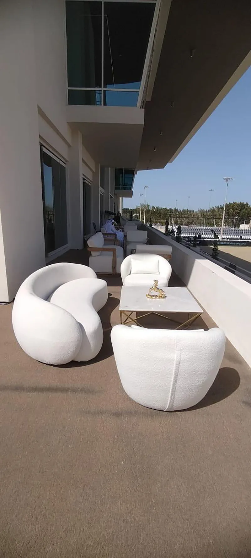 Outdoor hospitality lounge overlooking the equestrian arena with premium event furniture.