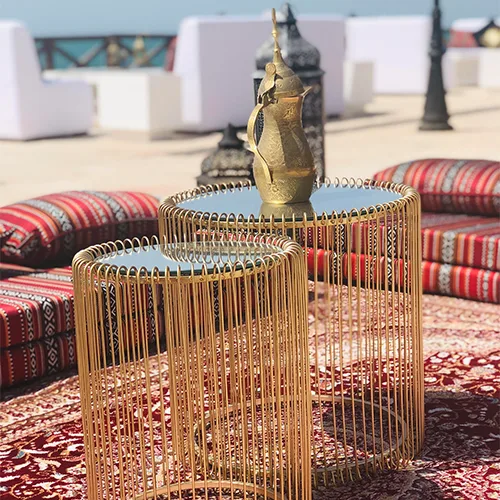 Elegant soft seating and side tables creating welcoming hospitality spaces for outdoor dining.