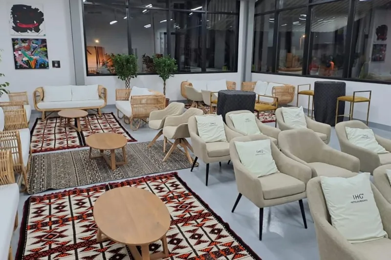 Evolution Furniture beige lounge seating with patterned pouffes across a spacious hospitality area