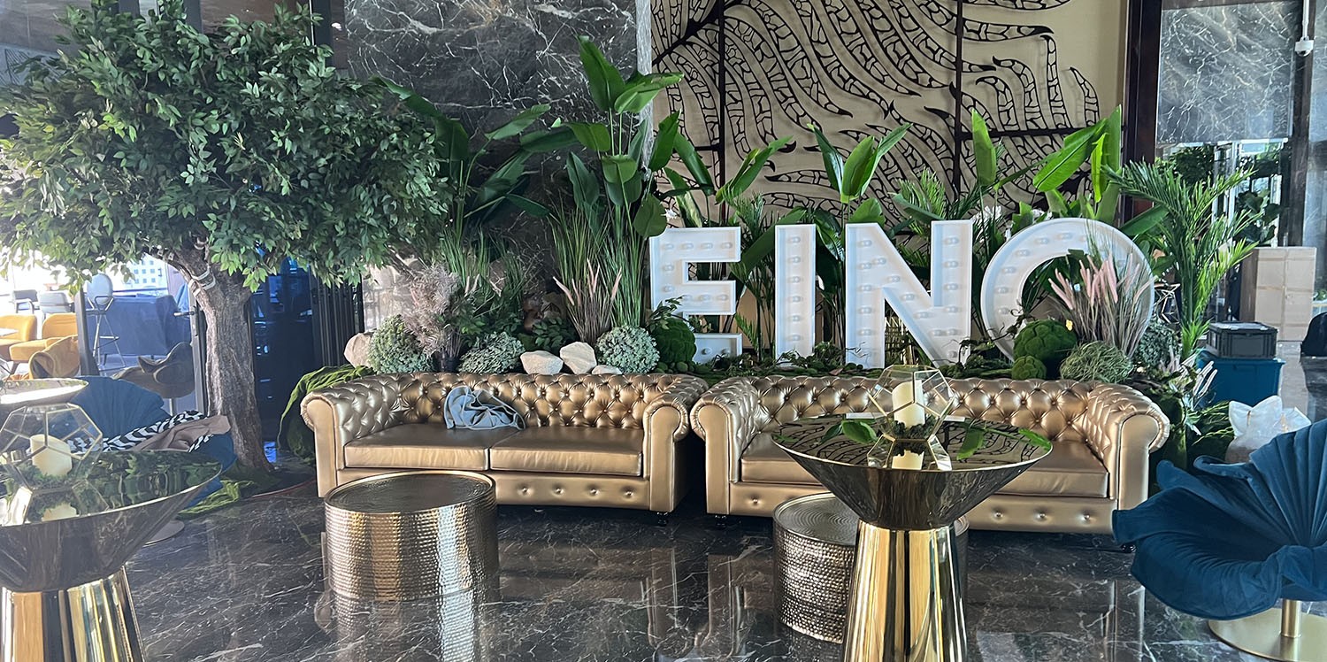 Premium temporary hospitality environment combining designer furniture with elegant botanical styling for EINO.