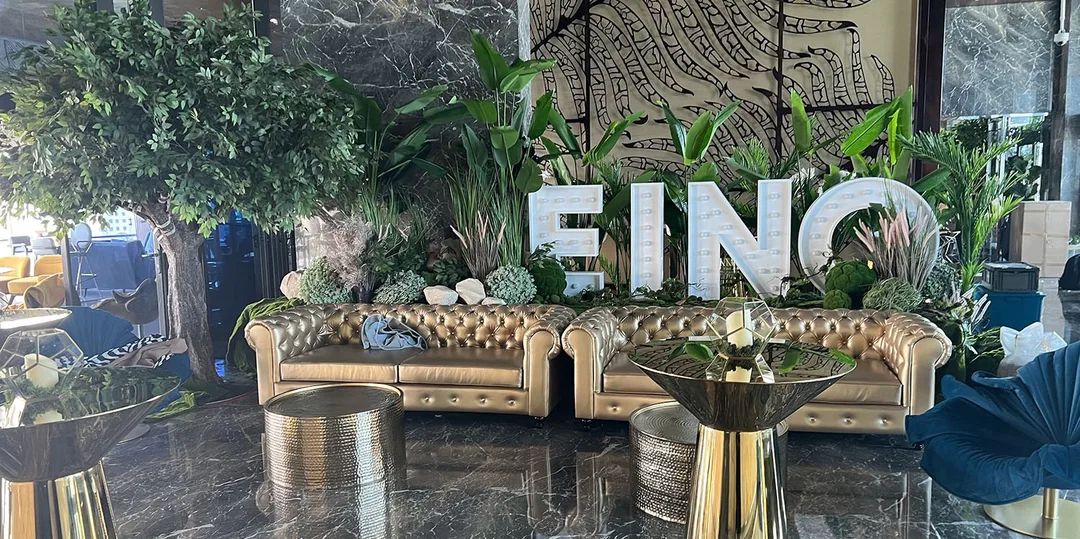 Premium temporary hospitality environment combining designer furniture with elegant botanical styling for EINO.