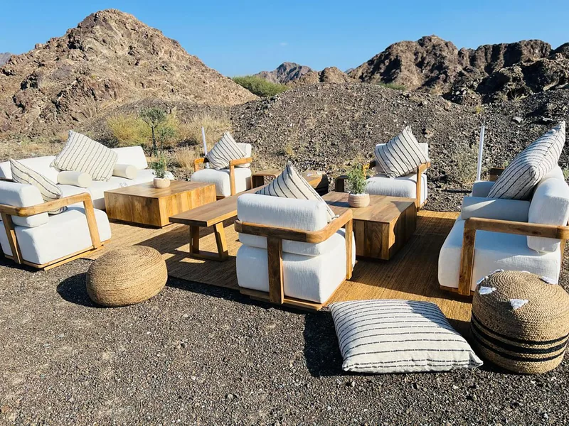 Outdoor hospitality furniture blending naturally with the surrounding landscape in Ras Al Khaimah.