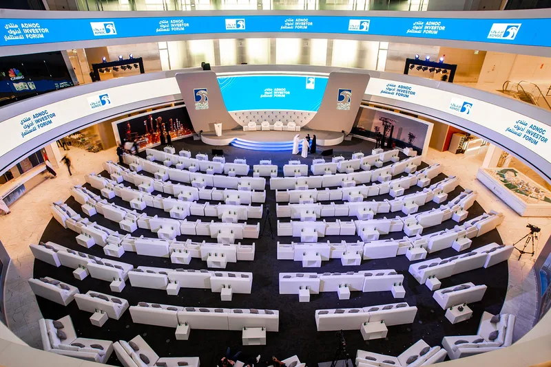 Executive lounge layout featuring white sofas and coffee tables for corporate hospitality.