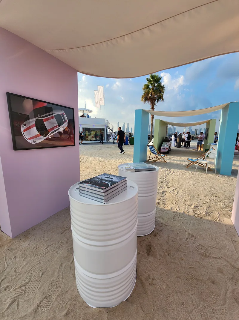 High tables and bar seating supporting flexible social spaces throughout the Icons of Porsche venue.