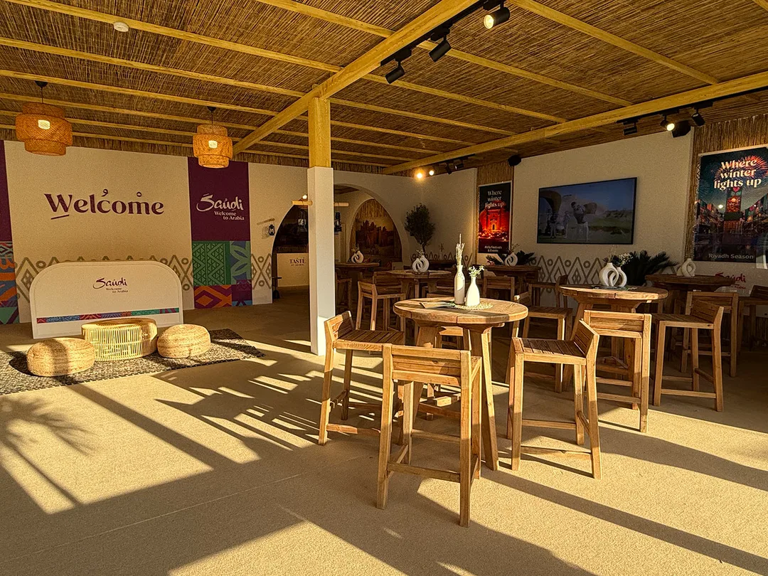 Reception furniture creating a welcoming arrival experience inside the Visit Saudi hospitality tent in Dubai.