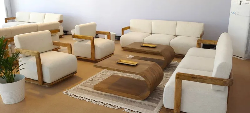White timber-framed sofas arranged as a balanced VIP hospitality lounge at XP Music Futures